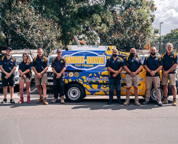 Knock-Down Pest Control team Knock-Down Pest Control team in front of the company van
